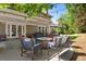 Inviting covered patio with comfortable seating, outdoor lighting, and a picturesque backyard view at 5643 S Fulton Way, Greenwood Village, CO 80111