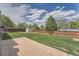 Large fenced backyard featuring a shed, green grass, and a brick paver patio at 17731 E Bails Pl, Aurora, CO 80017