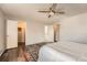 Spacious bedroom with an open closet, ceiling fan, dark wood floors and multiple doors at 17731 E Bails Pl, Aurora, CO 80017