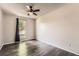 Bright, empty bedroom with a ceiling fan, wood floors, and a sun-filled window at 17731 E Bails Pl, Aurora, CO 80017