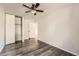 Empty bedroom with wood floors, a ceiling fan, open closet, and plenty of light at 17731 E Bails Pl, Aurora, CO 80017