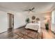 Inviting bedroom with modern ceiling fan, dark floors, and bright, natural light at 17731 E Bails Pl, Aurora, CO 80017