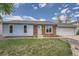 Charming home featuring blue siding, brick accents, lush green lawn, and a welcoming front entrance at 17731 E Bails Pl, Aurora, CO 80017