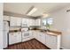 Functional kitchen with white cabinets, wood countertops, and modern appliances, perfect for cooking and entertaining at 17731 E Bails Pl, Aurora, CO 80017
