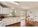 Bright kitchen with white cabinets, wood countertops, stainless steel sink, and sliding door access to the backyard at 17731 E Bails Pl, Aurora, CO 80017