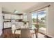 Bright eat-in kitchen with sliding doors to the backyard, white cabinets, and modern appliances at 17731 E Bails Pl, Aurora, CO 80017
