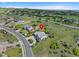 Scenic aerial view of a home with manicured landscaping in a green, rolling landscape at 5608 Raintree Dr, Parker, CO 80134