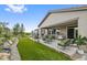 Spacious backyard featuring an outdoor patio, artificial grass, lush landscaping and mature trees at 5608 Raintree Dr, Parker, CO 80134