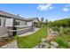 Lush backyard with manicured lawn, rock features, and inviting hot tub for ultimate relaxation at 5608 Raintree Dr, Parker, CO 80134