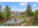 Expansive backyard with stone fire pit, ample seating, and lush landscaping for outdoor enjoyment at 5608 Raintree Dr, Parker, CO 80134