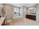 Spacious bathroom featuring tiled floors, glass shower, tub, and a dark vanity at 5608 Raintree Dr, Parker, CO 80134