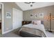 Bedroom with closet, neutral walls, gray carpet, ceiling fan, and decorative wall art at 5608 Raintree Dr, Parker, CO 80134
