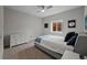 View of a bedroom with light gray walls, dresser, ceiling fan, and carpeted floors at 5608 Raintree Dr, Parker, CO 80134