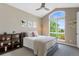 Bedroom with vaulted ceiling, large window, and neutral colors with decorative wall art at 5608 Raintree Dr, Parker, CO 80134