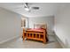 Bedroom features a ceiling fan, a log-style bed frame, and a side table at 5608 Raintree Dr, Parker, CO 80134