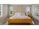 Comfortable bedroom featuring large windows and a wooden bed frame with soft pillows and bedding at 5608 Raintree Dr, Parker, CO 80134
