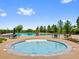 Inviting community pool area with spa and ample seating, perfect for relaxation and socializing at 5608 Raintree Dr, Parker, CO 80134