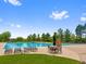 Large community pool with lounge chairs, tables, and lifeguard stand, perfect for summer fun at 5608 Raintree Dr, Parker, CO 80134