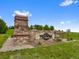 Stone entrance to Pradera community with manicured lawn and beautiful landscaping at 5608 Raintree Dr, Parker, CO 80134