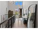 Bright entryway with hardwood floors, modern lighting, and decorative mirror reflecting natural light at 5608 Raintree Dr, Parker, CO 80134