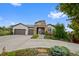 Charming home with a stone-accented entrance, 2-car garage, and well-maintained landscaping at 5608 Raintree Dr, Parker, CO 80134