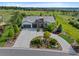Expansive home with landscaped front yard, circular driveway, and inviting curb appeal on a beautiful sunny day at 5608 Raintree Dr, Parker, CO 80134