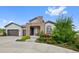 Charming home with a stone-accented entrance and well-maintained landscaping at 5608 Raintree Dr, Parker, CO 80134
