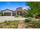 Attractive home with a stone-accented entrance, a three-car garage, and colorful landscaping in the front yard at 5608 Raintree Dr, Parker, CO 80134