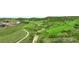 Scenic view of a lush green golf course with rolling hills, mature trees, and water features at 5608 Raintree Dr, Parker, CO 80134