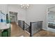 Hallway features hardwood floors, neutral walls, and staircase at 5608 Raintree Dr, Parker, CO 80134