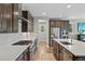 Stylish kitchen with dark cabinets, stainless steel appliances, and granite countertops for culinary enthusiasts at 5608 Raintree Dr, Parker, CO 80134