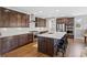 Spacious kitchen with dark wood cabinets, stainless steel appliances, and an island with bar stool seating at 5608 Raintree Dr, Parker, CO 80134