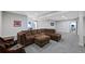Expansive living room with a plush brown sectional and comfortable seating arrangement at 5608 Raintree Dr, Parker, CO 80134