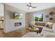 Comfortable living room with a stylish fireplace, TV, large sectional sofa, and window views at 5608 Raintree Dr, Parker, CO 80134