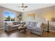 Cozy living room with a large sectional sofa, soft lighting, and views of the green exterior at 5608 Raintree Dr, Parker, CO 80134