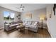 Spacious living room with a large gray sectional couch and elegant decor at 5608 Raintree Dr, Parker, CO 80134