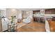 Open floor plan featuring a living room with fireplace flowing into a spacious kitchen with an island at 5608 Raintree Dr, Parker, CO 80134