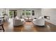Bright living room with large windows and sliding glass doors showcasing outdoor views and access to the backyard at 5608 Raintree Dr, Parker, CO 80134