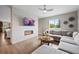 Bright living room featuring a modern fireplace, large TV, and comfortable gray sectional at 5608 Raintree Dr, Parker, CO 80134