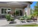 Inviting outdoor patio area with ample seating, lush landscaping, and a covered space at 5608 Raintree Dr, Parker, CO 80134
