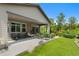 A covered patio with comfortable seating and lush landscaping creates a relaxing outdoor living space at 5608 Raintree Dr, Parker, CO 80134