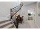 Stylish stairway featuring modern railings, a built-in desk, and an open office area at 5608 Raintree Dr, Parker, CO 80134