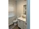 Cozy bathroom with a modern sink, white cabinets, and a window for natural light at 924 W 9Th Ave, Denver, CO 80204