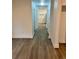 Bright hallway featuring modern flooring and neutral walls, leading to other rooms in the home at 924 W 9Th Ave, Denver, CO 80204