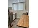 Efficient kitchen with stainless steel appliances, butcher block countertops and ample storage at 924 W 9Th Ave, Denver, CO 80204