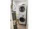 Functional laundry area with stacked washer and dryer, and a water heater at 924 W 9Th Ave, Denver, CO 80204