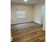 Bright living room with modern floors, neutral walls, and a large window for natural light at 924 W 9Th Ave, Denver, CO 80204