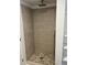 Modern walk-in shower with stylish tilework, a rainfall showerhead, and built-in shelving at 924 W 9Th Ave, Denver, CO 80204