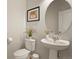Stylish powder room with a pedestal sink, round mirror, and minimalist design at 4205 E Iliff Ave # 5, Denver, CO 80222