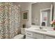Bright bathroom featuring colorful floral accents, a shower with curtain, and vanity at 4205 E Iliff Ave # 5, Denver, CO 80222